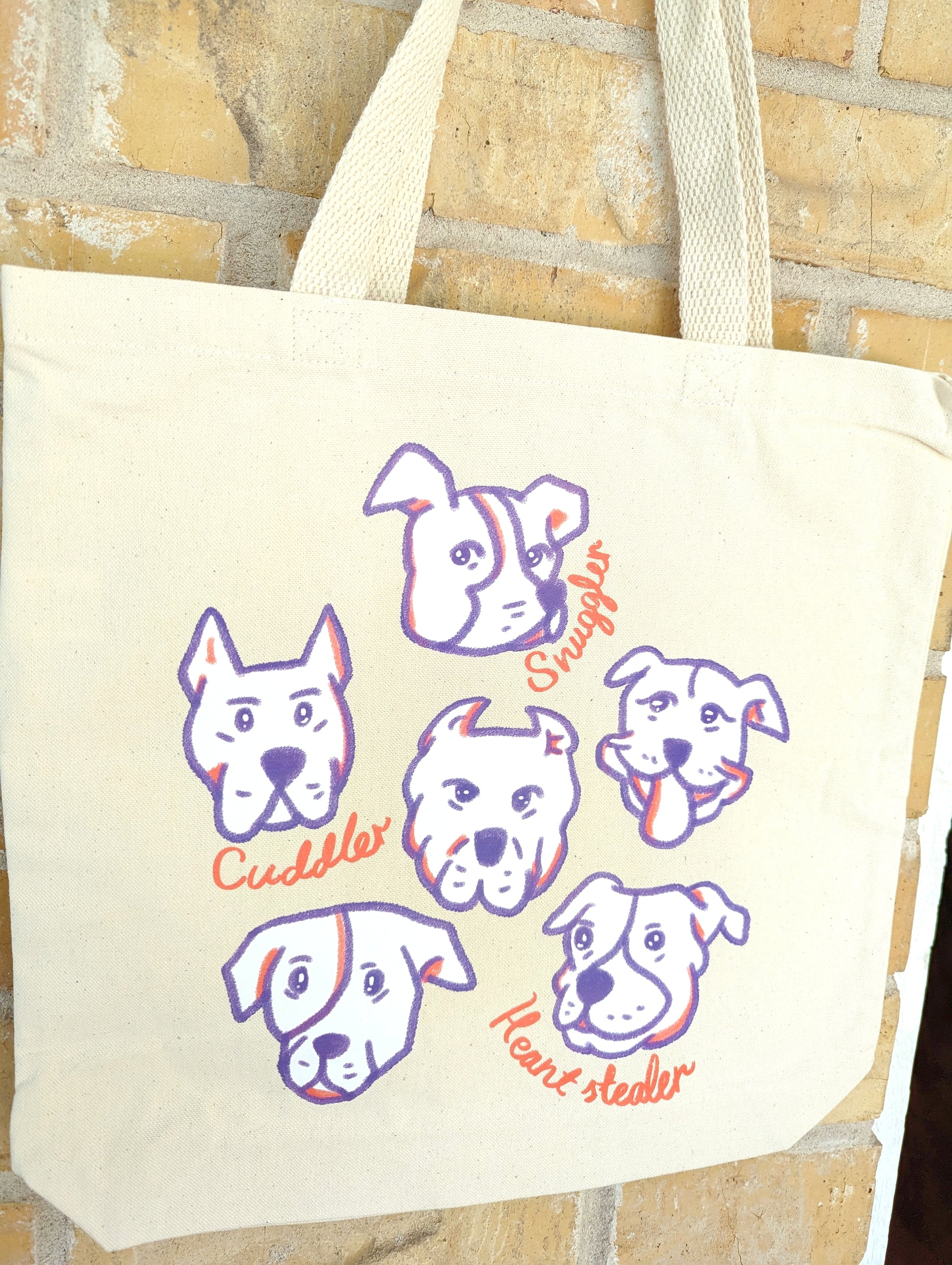 A cute and stylish tote bag featuring an adorable Pitbull print, perfect for Pitbull lovers and dog moms.